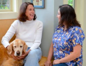 Clients, staff and dog in lobby of veterinary hospital near Agate Pass Bridge in Kitsap County.